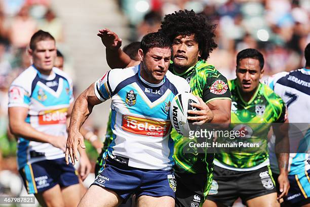 Mark Minichiello of the Titans makes a break during the NRL trial match between the New Zealand Warriors and the Gold Coast Titans at North harbour...