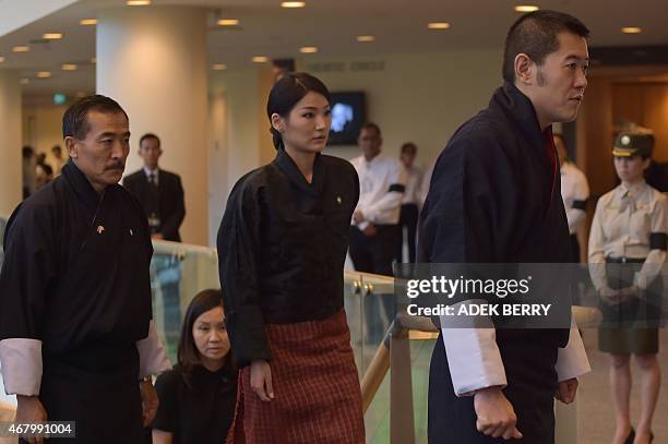 Bhutan's King Jigme Khesar Namgyel Wangchuck and Queen Jetsun Pema Wangchuck arrive at the University Cultural Center for the funeral service of...
