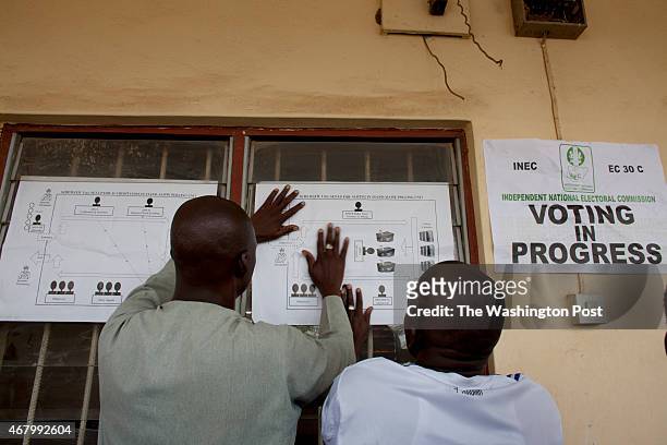 Kaduna Nigeria: Election officials post directions for the voting process at the LEA Primary School in the Kawo community as Africa's most populous...
