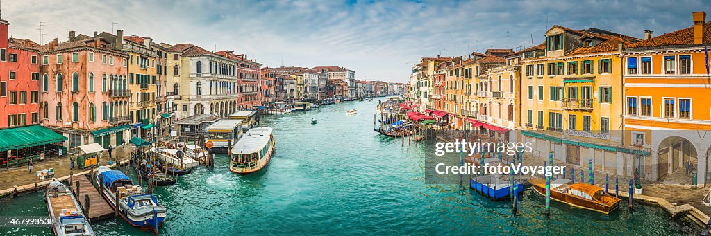 Venice boats on busy Grand Canal waterway between palazzo Italy
