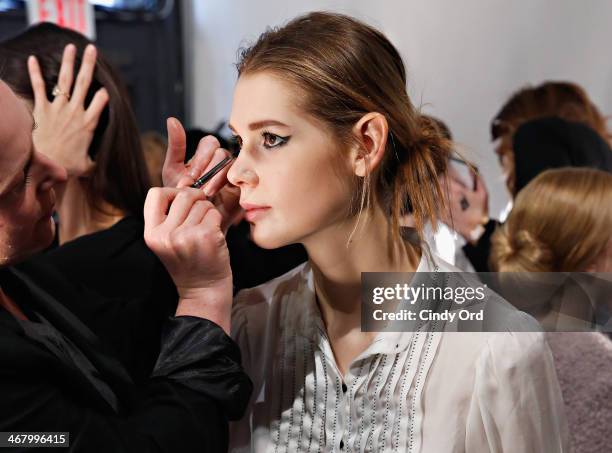 Model prepares backstage at the Christian Siriano fashion show during the Mercedes-Benz Fashion Week Fall 2014 at Eyebeam on February 8, 2014 in New...