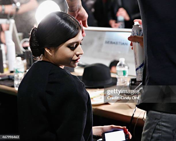 Model prepares backstage at the Christian Siriano fashion show during the Mercedes-Benz Fashion Week Fall 2014 at Eyebeam on February 8, 2014 in New...