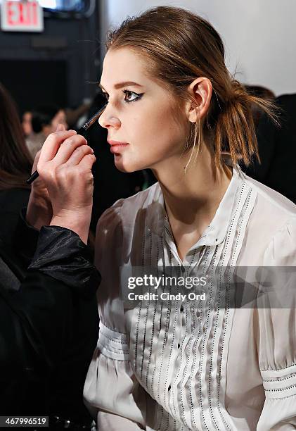 Model prepares backstage at the Christian Siriano fashion show during the Mercedes-Benz Fashion Week Fall 2014 at Eyebeam on February 8, 2014 in New...