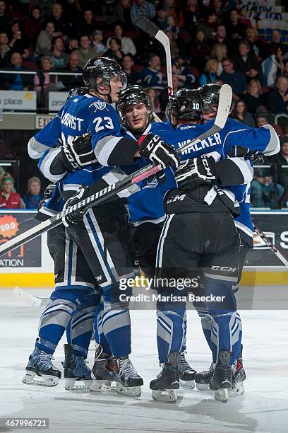 Axel Blomqvist of the Victoria Royals celebrates a goal with teammates against the Kelowna Rockets on February 8, 2014 at Prospera Place in Kelowna,...