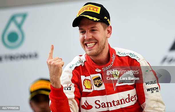 Sebastian Vettel of Germany and Ferrari celebrates on the podium after winning the Malaysia Formula One Grand Prix at Sepang Circuit on March 29,...