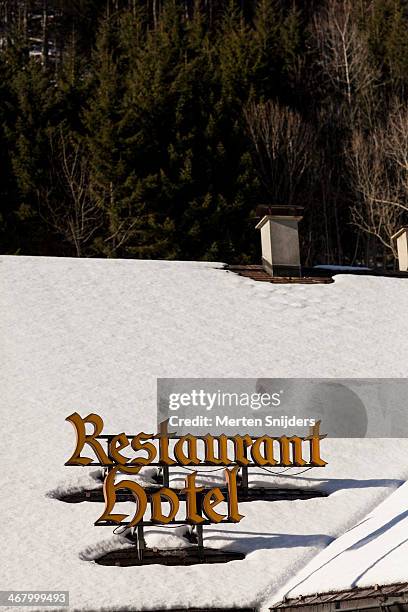 restaurant and hotel signs on snow covered roof - lungern stock pictures, royalty-free photos & images