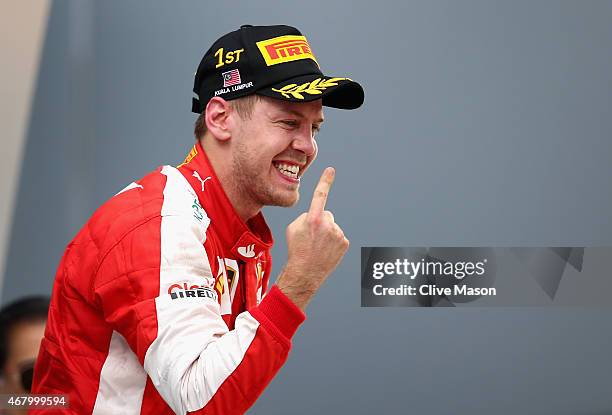 Sebastian Vettel of Germany and Ferrari celebrates on the podium after winning the Malaysia Formula One Grand Prix at Sepang Circuit on March 29,...