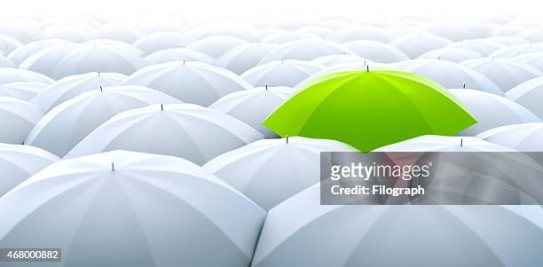 green umbrella. different, leader, unique, boss, individuality, original, special concept - juxtaposition stock pictures, royalty-free photos & images