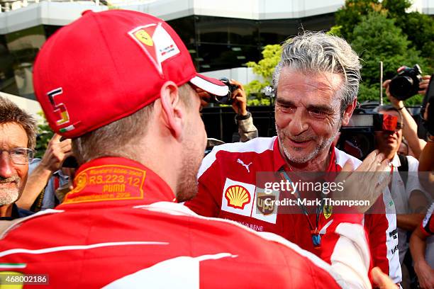 Sebastian Vettel of Germany and Ferrari celebrates with Ferrari Team Principal Maurizio Arrivabene after the Malaysia Formula One Grand Prix at...
