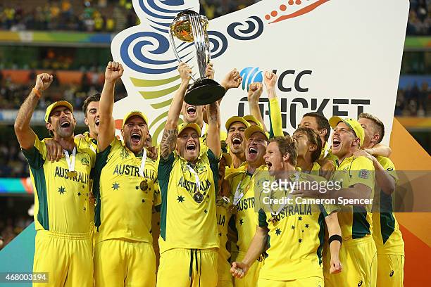 Michael Clarke of Australia holds the trophy aloft as Australian players celebrate winning the 2015 ICC Cricket World Cup final match between...