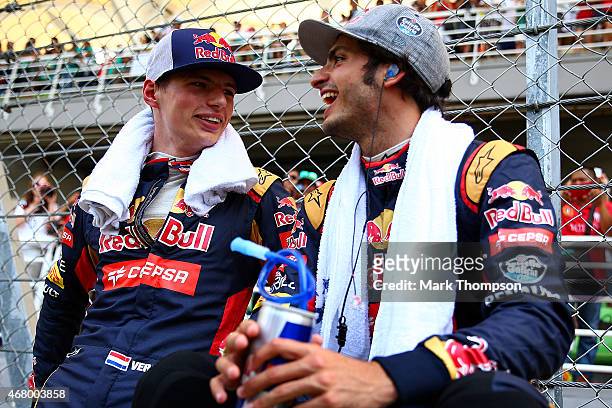 Max Verstappen of Netherlands and Scuderia Toro Rosso and Carlos Sainz of Spain and Scuderia Toro Rosso speak on the grid before the Malaysia Formula...