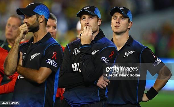 Grant Elliott, Martin Guptill and Matt Henry of New Zealand look dejected after defeat during the 2015 ICC Cricket World Cup final match between...