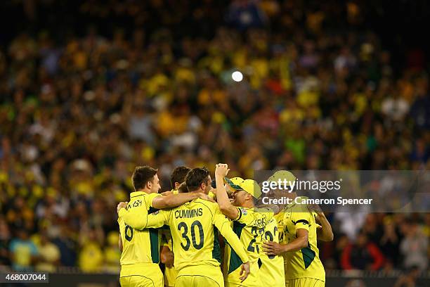 Australian players celebrate winning the 2015 ICC Cricket World Cup final match between Australia and New Zealand at Melbourne Cricket Ground on...