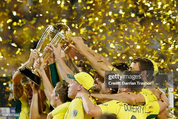 Australian players celebrate with the tophy after the 2015 ICC Cricket World Cup final match between Australia and New Zealand at Melbourne Cricket...