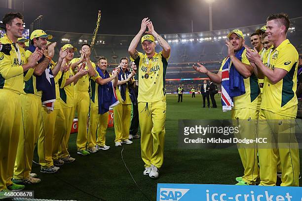 Australian captain Michael Clarke is clapped off by teamates after winning during the 2015 ICC Cricket World Cup final match between Australia and...