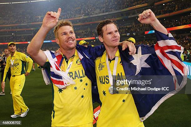 David Warner of Australia and Shane Watson celebrate winning during the 2015 ICC Cricket World Cup final match between Australia and New Zealand at...