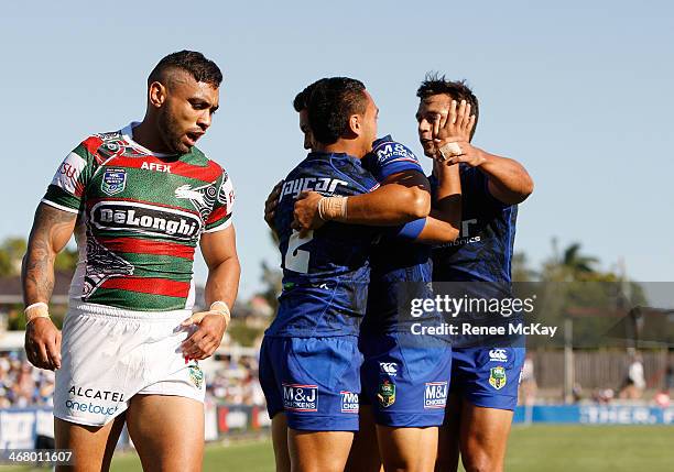 Bulldogs try scorer Drury Low celebrates his try with Sam Perrett and Tim Lafai during the NRL trial match between the Canterbury Bulldogs and the...