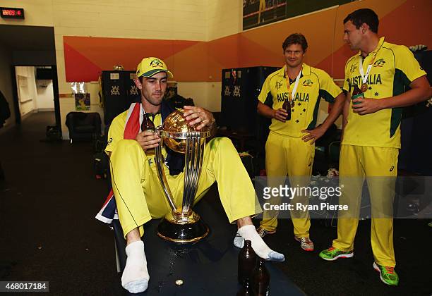 Glenn Maxwell, Shane Watson and Josh Hazlewood of Australia celebrate with the trophy in the change rooms during the 2015 ICC Cricket World Cup final...