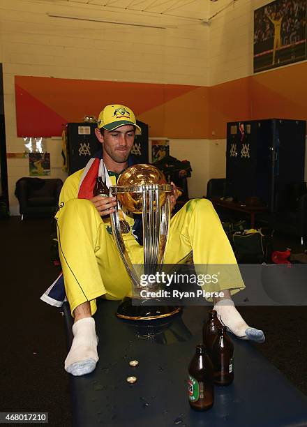Glenn Maxwell of Australia celebrates with the trophy in the change rooms during the 2015 ICC Cricket World Cup final match between Australia and New...
