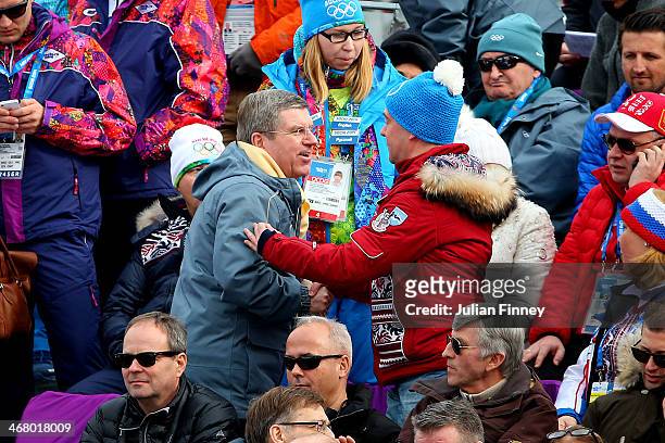 Russian Prime Minister Dmitry Medvedev greets during International Olympic Committee President Thomas Bach during the Alpine Men's Downhill on day...