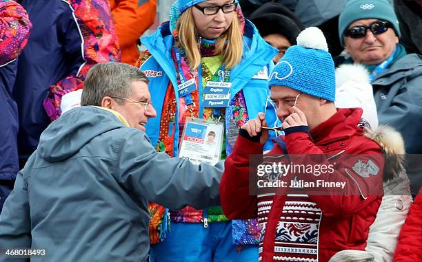 Russian Prime Minister Dmitry Medvedev speaks with International Olympic Committee President Thomas Bach during the Alpine Men's Downhill on day two...