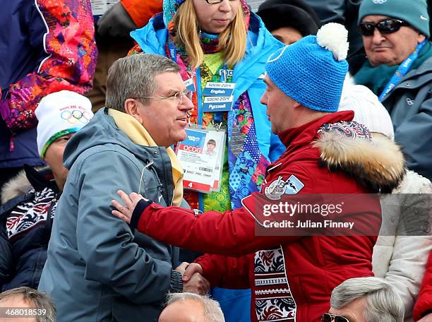 Russian Prime Minister Dmitry Medvedev speaks with International Olympic Committee President Thomas Bach during the Alpine Men's Downhill on day two...