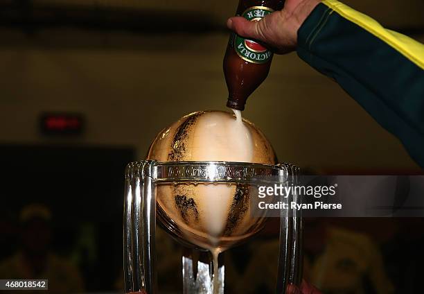 Beer is poured on the trophy in the change rooms during the 2015 ICC Cricket World Cup final match between Australia and New Zealand at Melbourne...