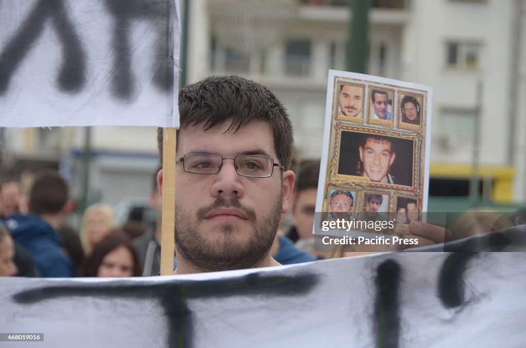 Demonstrators hold a photos of bullying victims in Syntagma...