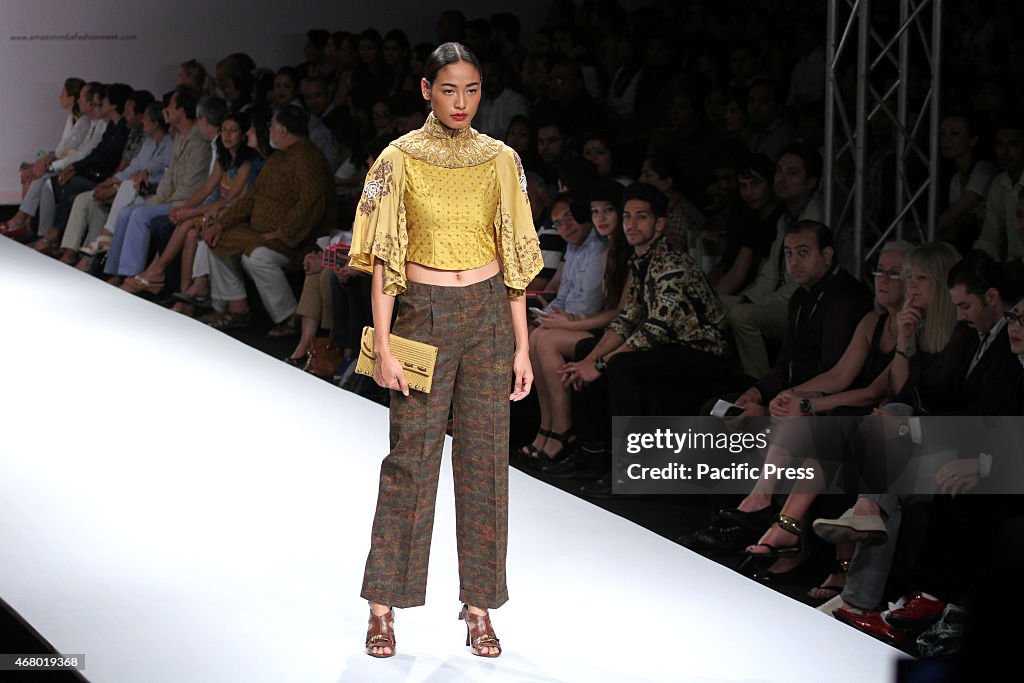 A model walks the ramp to showcase a creation By Indian...