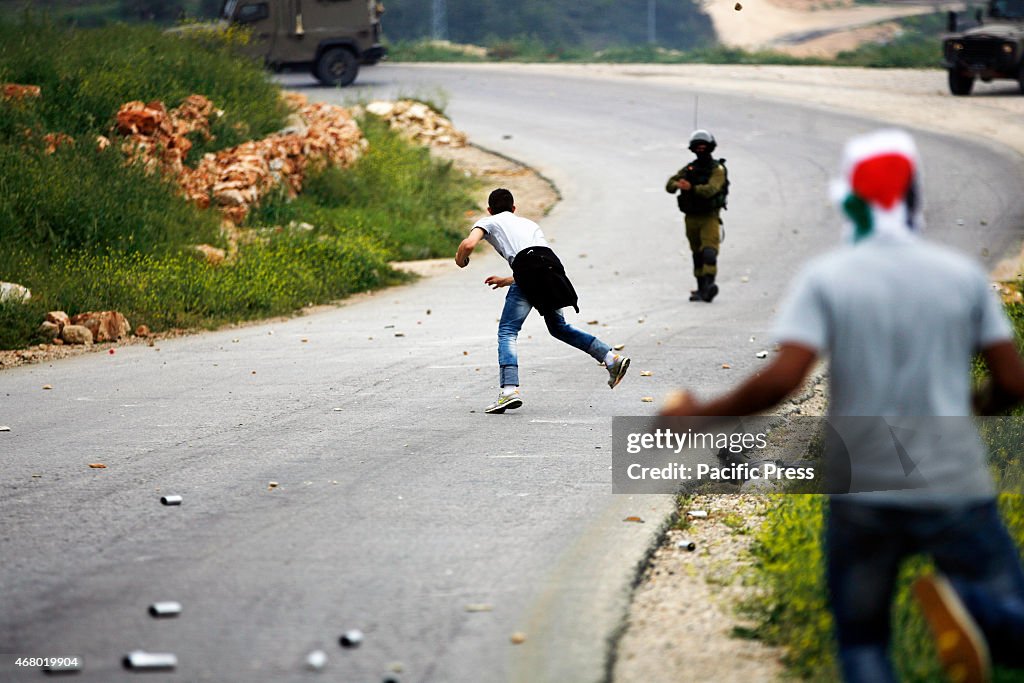 A Palestinian demonstrator hurl a stone toward Israeli...