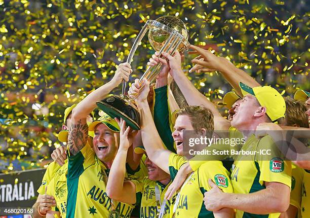 Australian captain Michael Clarke, Steven Smith and Australian players celebrate with the World Cup trophy as they celebrate after Australia won the...