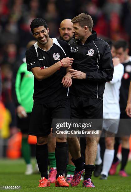 Luis Suarez and Steven Gerrard of the Gerrard XI share a laugh at full time following the Liverpool All-Star Charity match at Anfield on March 29,...