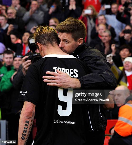 Steven Gerrard of Liverpool shares a hug with Fernando Torres at the end of the Liverpool All Star Charity Match at Anfield on March 29, 2015 in...
