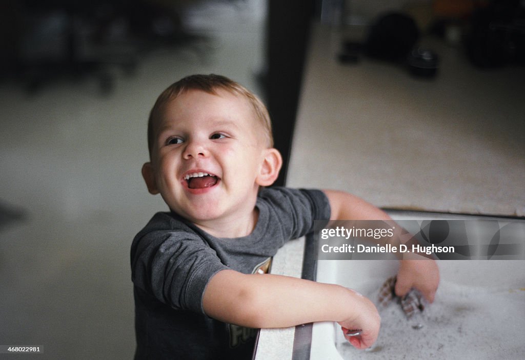 Happy Toddler Washing Dishes