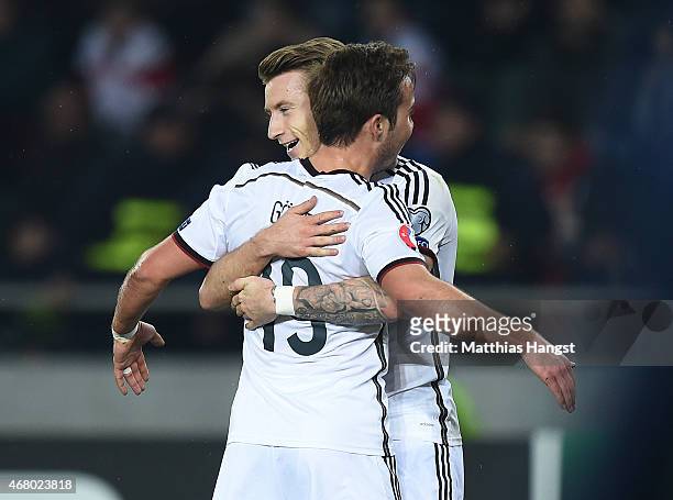 Marco Reus of Germany celebrates with his team-mate after scoring his team's first goal during the EURO 2016 Group D Qualifier match between Georgia...