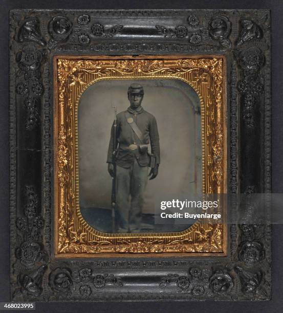 Daguerreotype of an African-American soldier in Union uniform with bayoneted musket, cap box, and cartridge box, 1862.