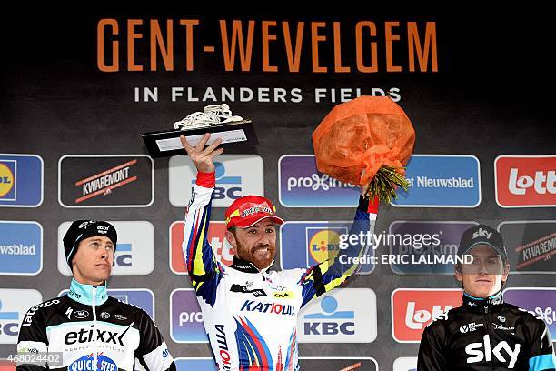 Dutch Niki Terpstra of team Ettix - Quick-Step, Italian Luca Paolini of Team Katusha and British Geraint Thomas of Team Sky celebrate on the podium...