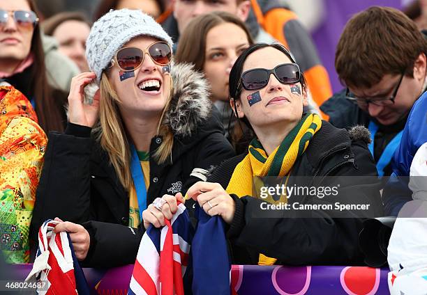 Spectators show their support as they watch the Women's Snowboard Slopestyle Finals during day two of the Sochi 2014 Winter Olympics at Rosa Khutor...