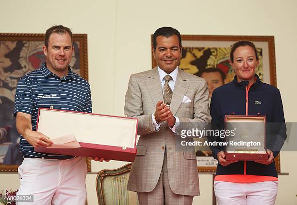 Richie Ramsay of Scotland and Gwladys Nocera of France pose with HRH Prince Moulay Rachid of Morocco and their winner's trophies after the final...