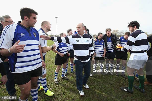 Land Rover ambassador Sir Clive Woodward talks to the players from Racal Decca RFC during the half time break during the launch of the Land Rover...