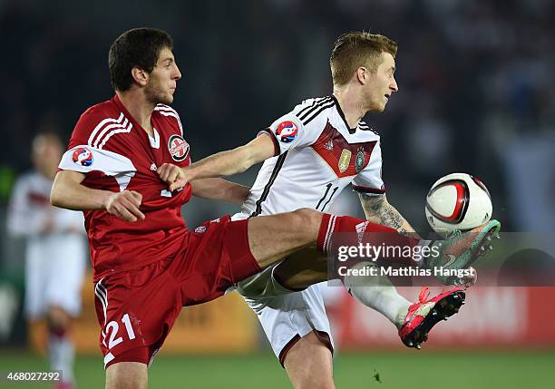 Marco Reus of Germany and Lasah Dvali of Georgia compete for the ball during the EURO 2016 Group D Qualifier match between Georgia and Germany at...