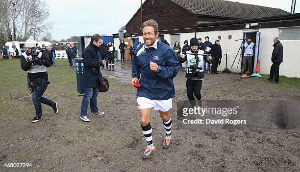 Land Rover ambassador Jonny Wilkinson runs from the club house to deliver the kicking tee during the launch of the Land Rover Rugby World Cup 2015...