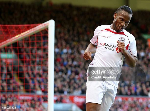 Team Carragher's Didier Drogba celebrates scoring their second goal against Team Gerrard during the Liverpool All-Star charity soccer match at...