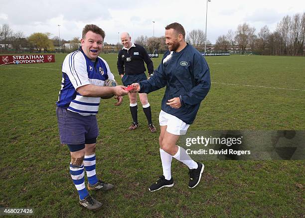 Matt Giteau, of Australia and Toulon delivers the kicking tee to Robert Holmes, the Racal Decca RFC kicker during the launch of the Land Rover Rugby...