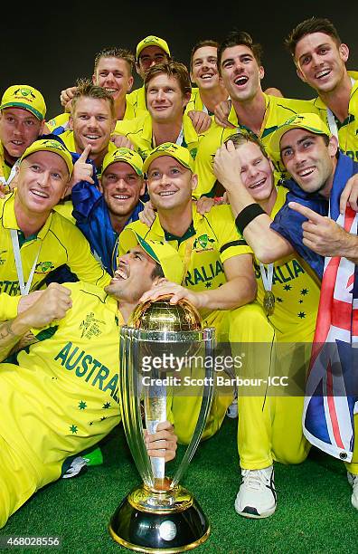Australian captain Michael Clarke and the Australian team celebrate with the World Cup trophy as they celebrate after Australia won the 2015 ICC...