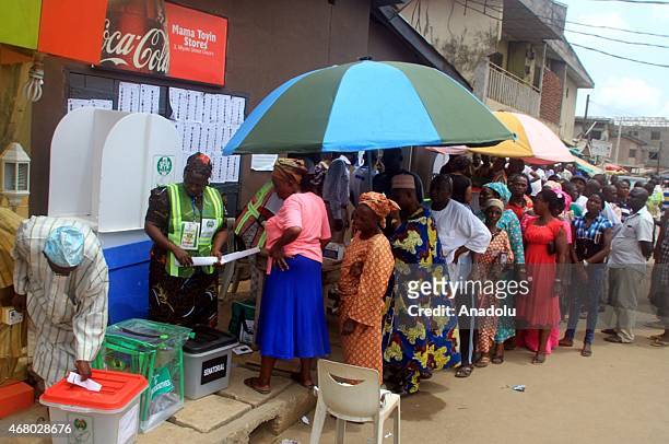 Voters wait in a queue in front of the election centre in the city of Lagos, Nigeria on March 29, 2015. The parliamentary and state ministerial...
