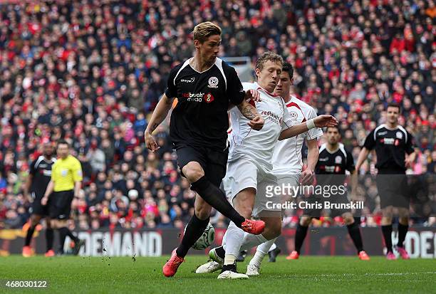 Fernando Torres of the Gerrard XI in action with Lucas Leiva of the Carragher XI during the Liverpool All-Star Charity match at Anfield on March 29,...