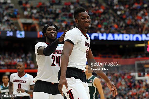 Chinanu Onuaku of the Louisville Cardinals reacts with teammate Montrezl Harrell in the first half of the game against the Michigan State Spartans...