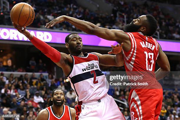 John Wall of the Washington Wizards is defended by James Harden of the Houston Rockets in the second half at Verizon Center on March 29, 2015 in...