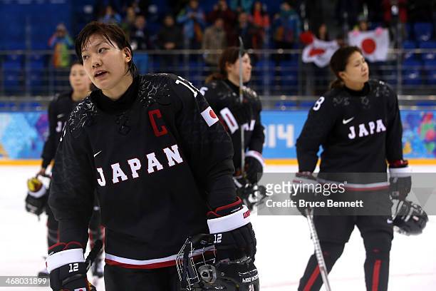 Chiho Osawa of Japan reacts after the Women's Ice Hockey Preliminary Round Group B Game on day two of the Sochi 2014 Winter Olympics at Shayba Arena...